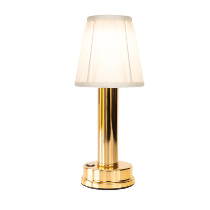 Gold table lamp with a white shade on a white background