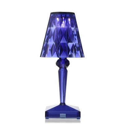 Blue geometric-patterned table lamp on a white background