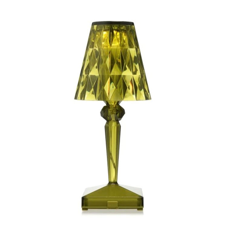 Green glass table lamp with a faceted design on a white background