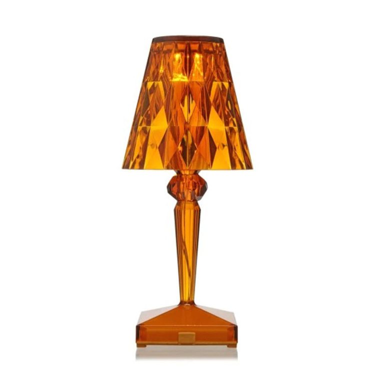 Orange table lamp with a geometric design on a white background