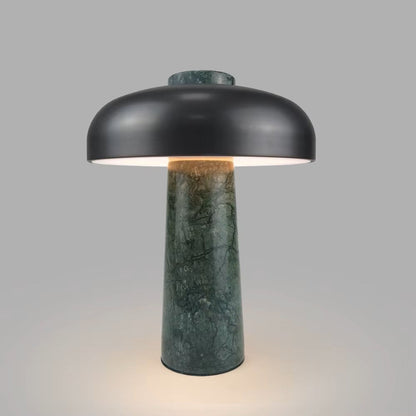 Table lamp with black shade and green marble base on a gray background