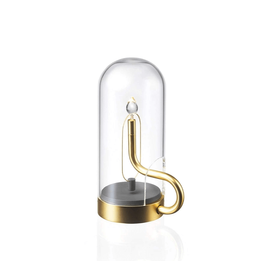 Decorative item with a gold handle and clear glass cover on a white background