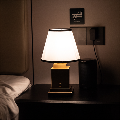 Table lamp on a nightstand in a dimly lit room