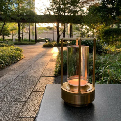 Decorative lantern with a candle on a table outdoors