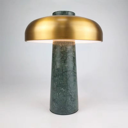 Table lamp with gold shade and green marble base on a white background